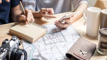 Travelers planning an Orlando vacation with a map and camera