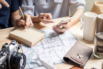 Travelers planning an Orlando vacation with a map and camera